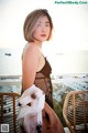 A woman in a black lingerie posing on a balcony.