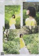 A woman in a yellow top and white skirt standing in the woods.