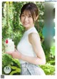 A woman holding a jar of milk with a fork in it.