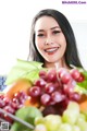 A woman holding a basket of fruit in her hands.